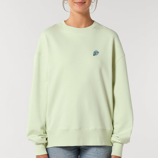 Mintgrünes oversize sweatshirt mit gestickter Pflanze auf der Brust. Neon. Weiter Bund unten.